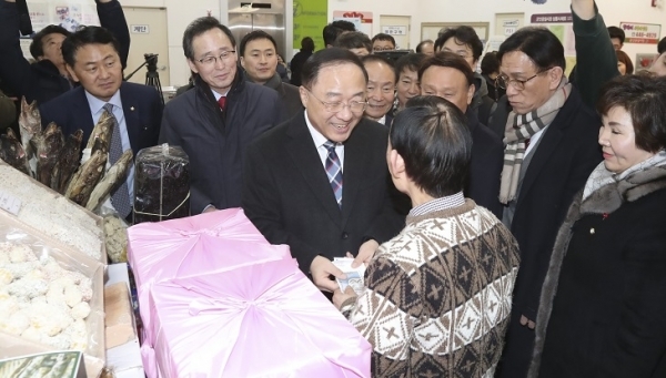 홍남기 경제부총리 겸 기획재정부 장관이 21일 군산 공설시장을 찾아 송하진 도지사와 설 명절 민생점검과 장보기 행사를 하며 상인들과 이야기를 나누고 있다. 전북도 제공