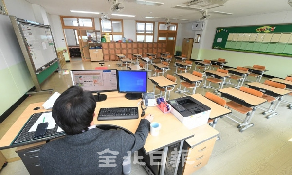 코로나19가 장기화 되면서 교육부는 17일 유초중고 개학을 4월 6일로 세번째 연기한 가운데 전주의 한 초등학교에서 교사가 텅빈 교실에 홀로 앉아 학사일정을 살피고 있다. 오세림 기자