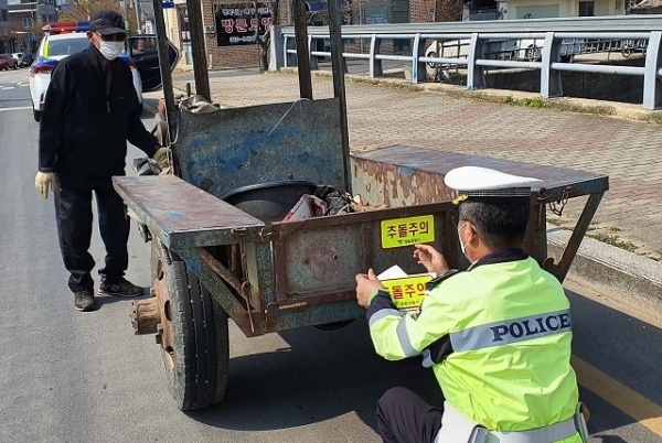 정읍경찰이 농기계 교통사고 예방을 위해 경운기에 야광반사지를 부착하고 있다.