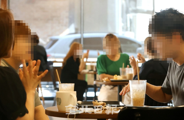 19일 전주시의 한 카페에서 방문객들이 마스크를 착용하지 않은 채 대화를 나누고 있다. 정부의 카페 방역 수칙에 의하면 대화할 때 모두 마스크를 착용해야 하며 종업원은 방문객들에게 방역수칙 준수 참여 안내를 해야 한다. 조현욱 기자