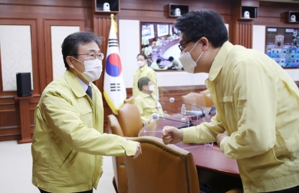 권덕철 신임 보건복지부 장관(왼쪽)이 임명된 후 처음으로 24일 오전 정부서울청사에서 열린 신종 코로나바이러스 감염증(코로나19) 대응 중앙재난안전대책본부(중대본) 회의에 참석해 인사하고 있다. /연합뉴스