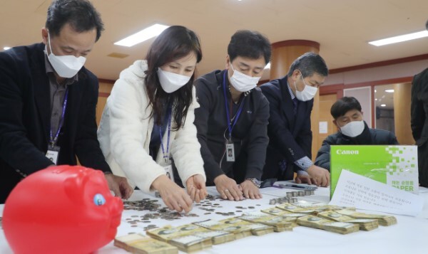 29일 전주시 노송동주민센터에서 직원들이 '얼굴 없는 천사'가 놓고 간 성금을 세고 있다. '얼굴 없는 천사'는 7,012만 8,980원의 성금과 함께 '지난해 저로 인한 소동이 일어나서 죄송합니다. 코로나로 인하여 힘들었던 한해였습니다. 이겨내실 거라 믿습니다. 소년소녀 가장 여러분 새해 복 많이 받으시고 건강하세요. 감사합니다.'라는 글을 함께 보내왔다. /전북사진기자단