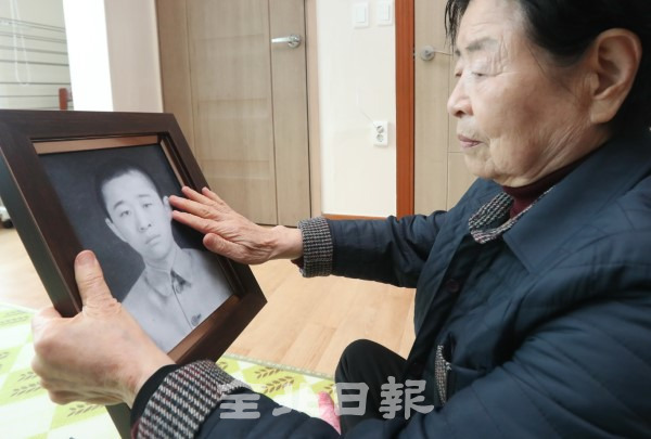 30일 변복순 할머니가 6.25 전쟁으로 헤어진 남편 황의영 씨(당시 24살)를 그리워하며 사진을 어루만지고 있다. /조현욱 기자