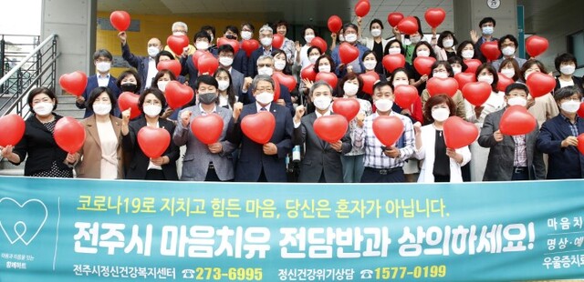 지난해 6월 2일 전주도시혁신센터에서 열린 전주시 마음치유대책반 출범식에서 김승수 시장 등 참석자들이 하트 풍선을 들고 기념촬영을 하고 있다.