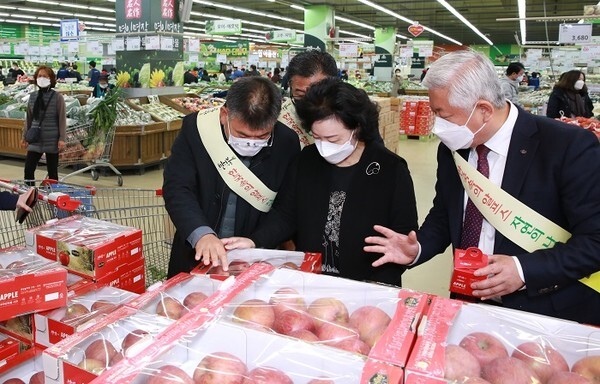 18일 서울 양재동 하나로마트에서 열린 무주 반딧불사과 관측행사에서 황인홍 군수(오른쪽)가 소비자에게 반딧불사과의 맛과 품질에 대해 설명하고 있다.